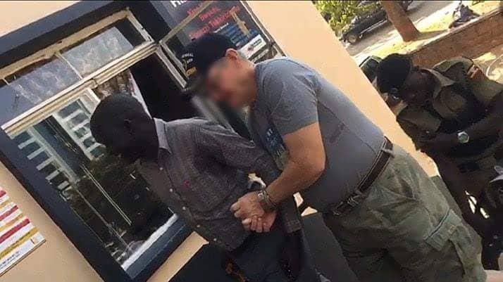 Police Arrest American Filmed Aulting Ugandan Hotel Jimmy Taylor Wearing Cap Who Claims To Be A And An Ex Us Marine Being Led Central Police Station